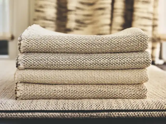 Folded cream and neutral textured fabrics showing contrasting weaves