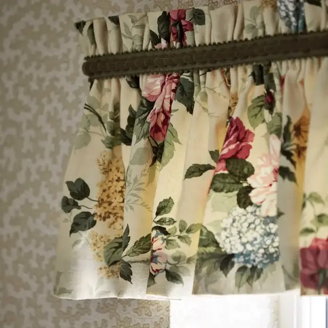 Detailed curtain heading with patterned fabric and decorative trim