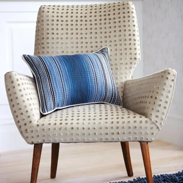 Dotted cut velvet upholstery on a contemporary armchair