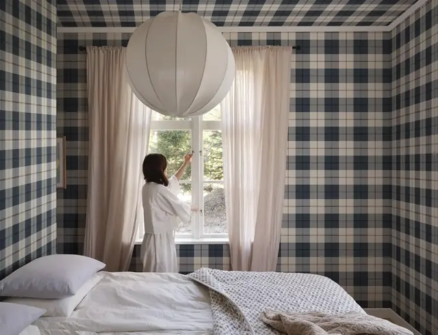 Dark blue Sandberg oversized check wallpaper across a modern bedroom