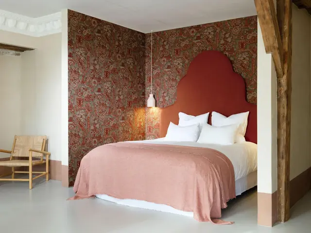 Decorative red tapestry wallcovering in a bedroom