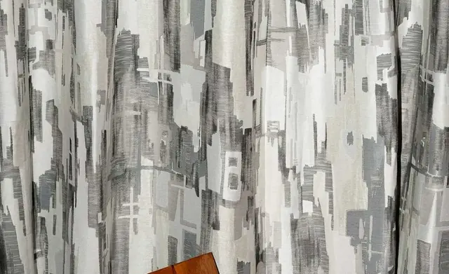 Dedar Sassongher fabric hanging in soft grey curtains