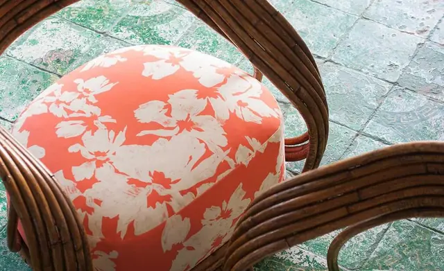 Coral floral Dedar fabric upholstered on a sculptural chair