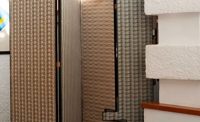 Layered screens upholstered in textural Dedar fabrics
