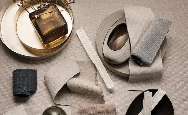 Neutral designer furnishing fabrics arranged to show different colours and textures