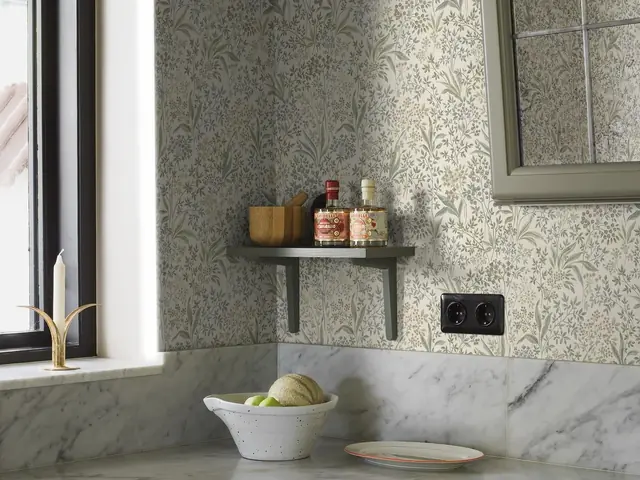 Designer wallpaper above stone worktops in a contemporary kitchen