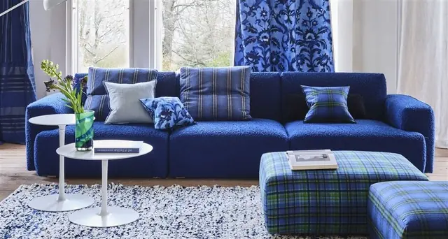Designers Guild blue upholstered sofa and coordinating furnishings