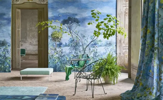Designers Guild scenic wallcovering, curtains and furnishings in a blue interior