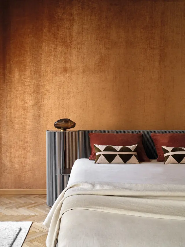Elitis Alcove II copper velvet wallcovering in a luxury bedroom