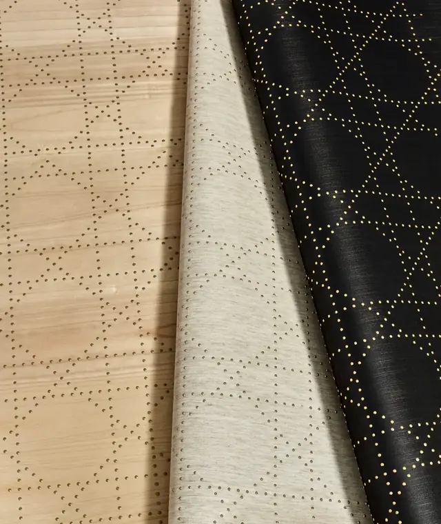 Close-up of wallcoverings with precisely applied raised rivet patterns