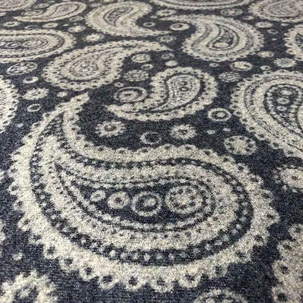 Close-up paisley fabric with curved teardrop-shaped boteh motifs