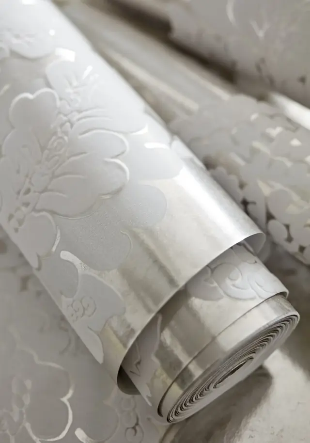 Close-up of Thibaut Rowan flock damask wallpaper with a raised textured surface