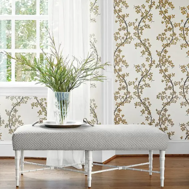 Floral trellis wallpaper with trailing branches and metallic flowers in a light traditional room