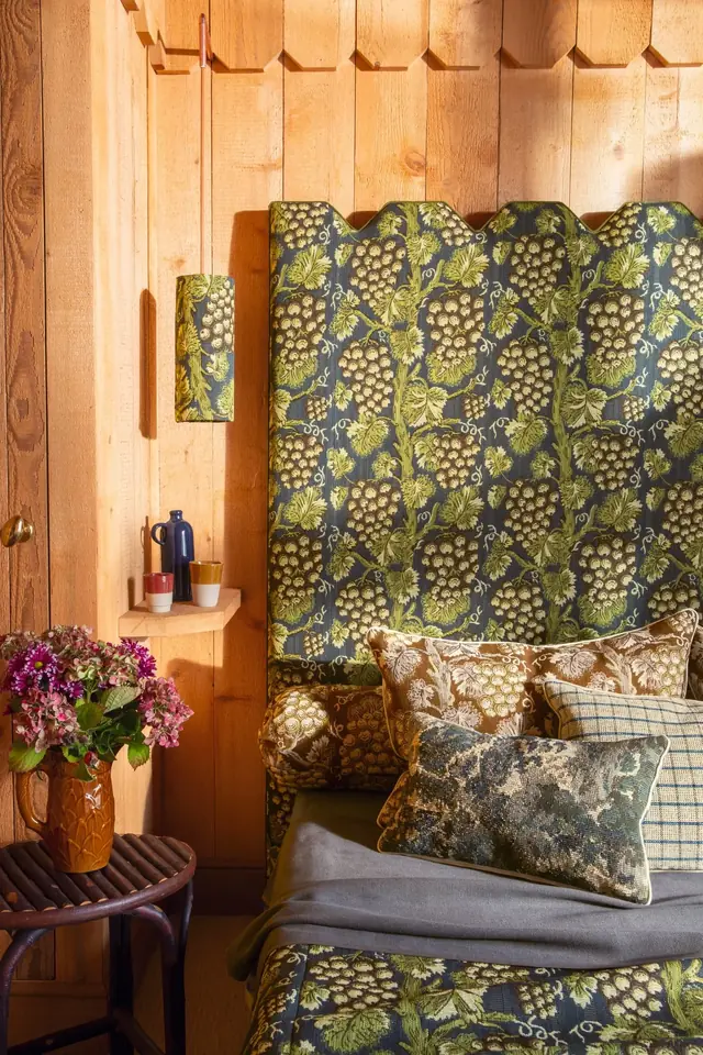 Botanical jacquard fabric used on a high-backed upholstered seat with coordinating cushions