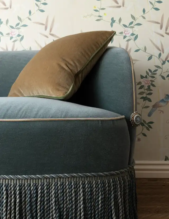 Blue upholstered chair finished with bullion fringe
