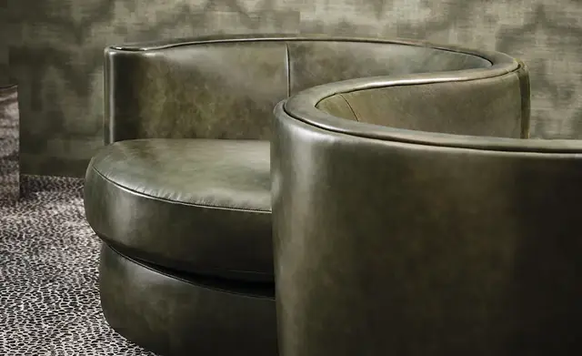 Curved chairs upholstered in deep green genuine leather