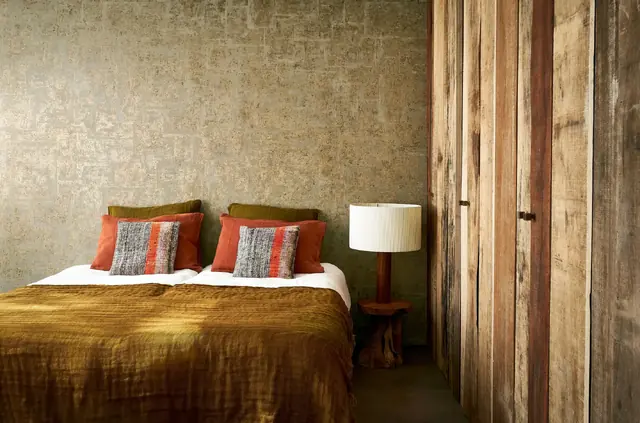 Gold quilted metallic foil wallpaper in a contemporary bedroom