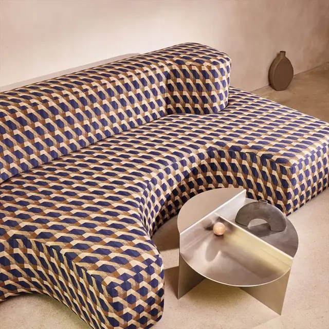 Blue and ochre graphic geometric upholstery used on a sculptural sofa