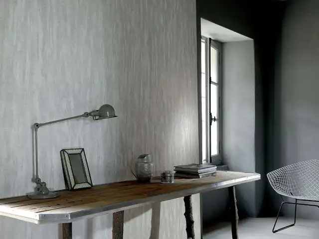 Atmospheric grey mural wallpaper in a dark architectural room