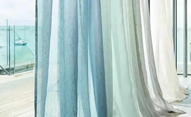 Blue and neutral Harlequin sheer fabrics at a large window