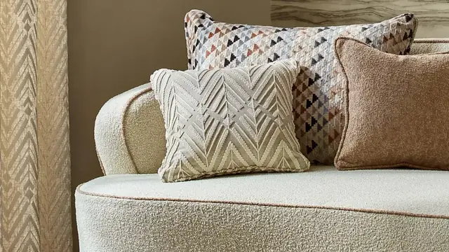 Harlequin textured upholstery fabric used on a contemporary sofa and cushions