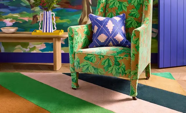 Harlequin patterned chair, cushion and rug in an expressive interior