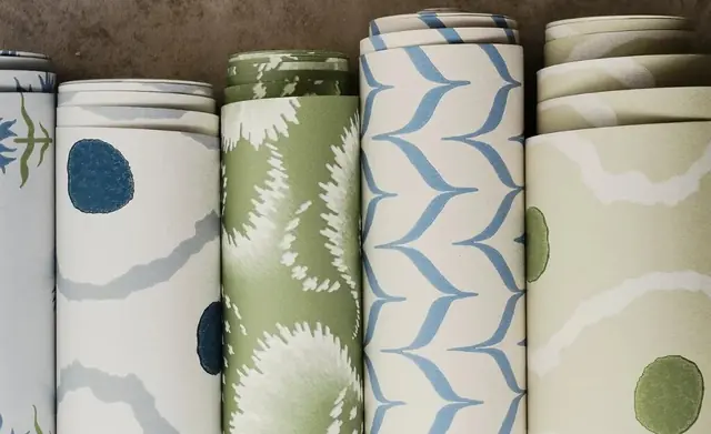 Rolls of Harlequin wallpaper in blue, green and neutral colourways