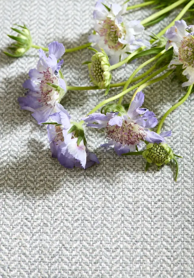 Textured grey herringbone fabric styled with flowers