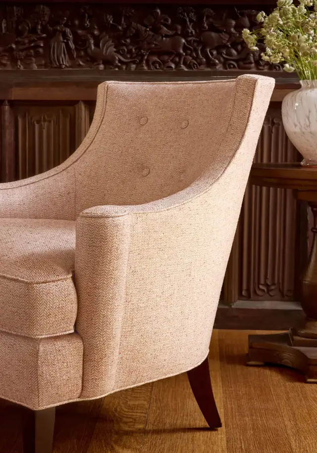 Warm herringbone upholstery fabric on a curved armchair
