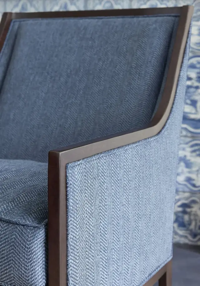 Blue herringbone upholstery showing tailored seams and piping