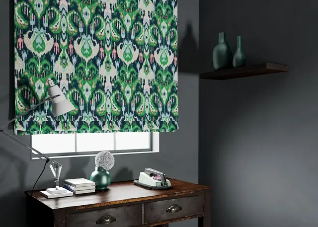 Green patterned Roman blind made in an Ikat-inspired fabric