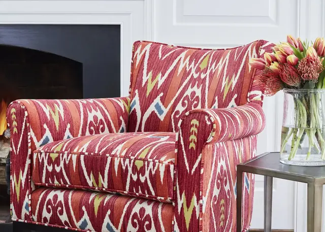 Armchair upholstered in a red Ikat-style patterned fabric