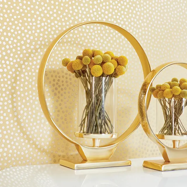 Irregular white and metallic spots on yellow wallpaper