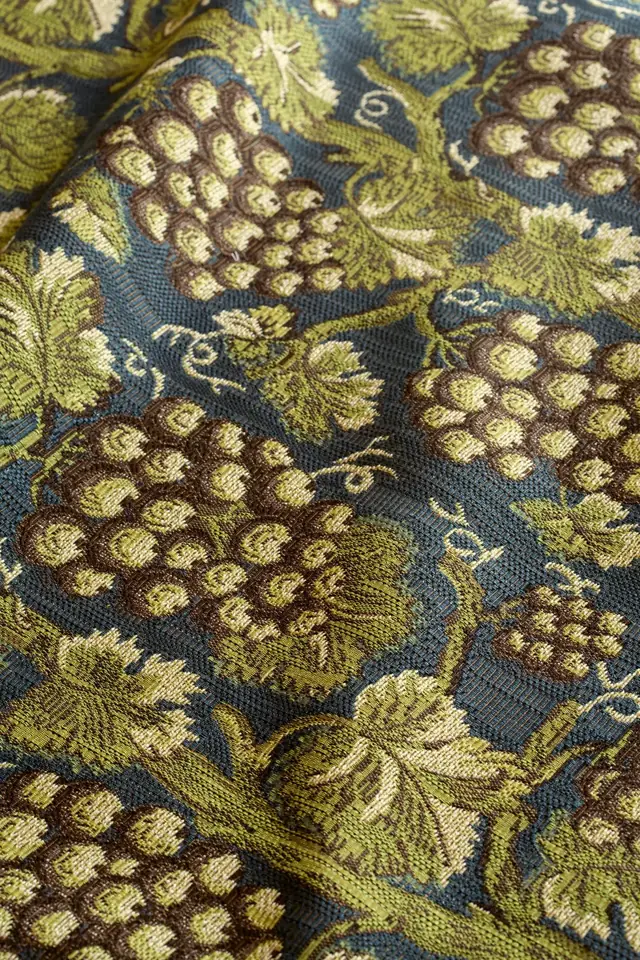 Close-up of botanical jacquard fabric showing the woven yarn structure