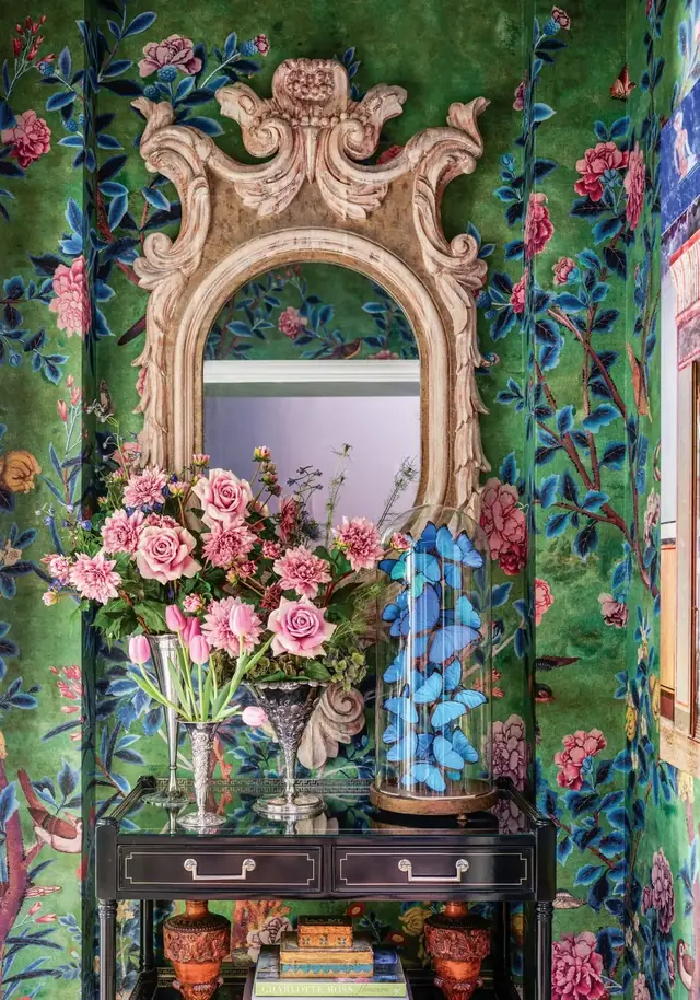 Colourful Japanese-influenced Chinoiserie wall design with blossom, birds and a carved mirror