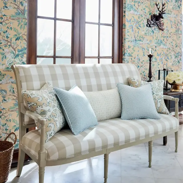 Large-scale neutral check upholstery used across a wooden-framed sofa