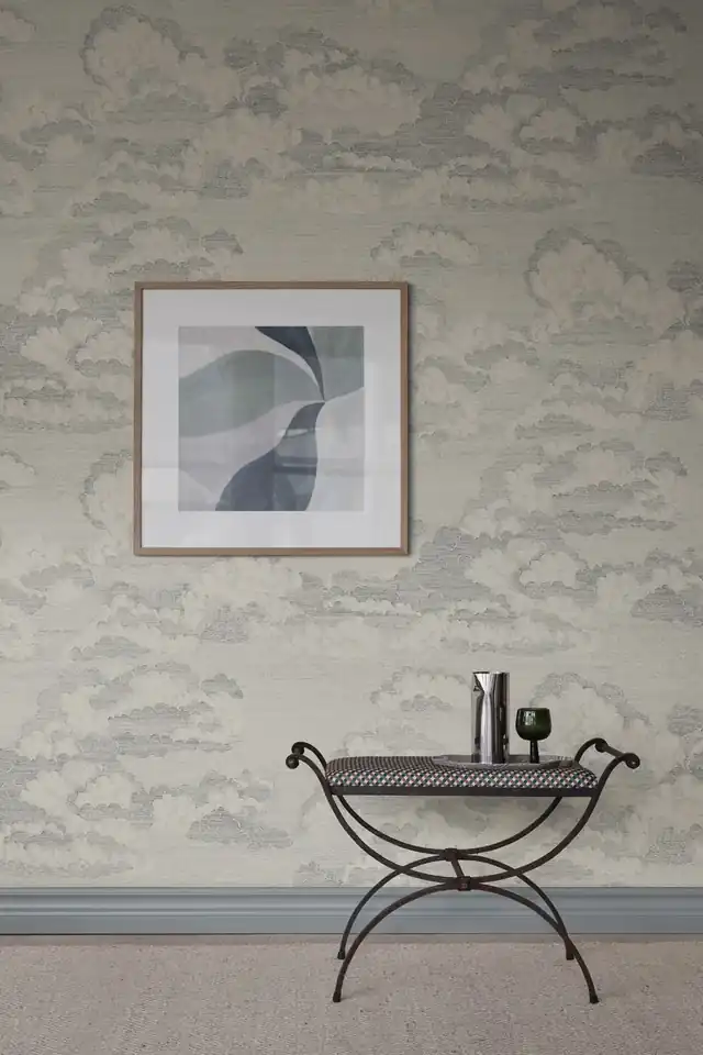 Soft blue scenic wallpaper above a hallway console table