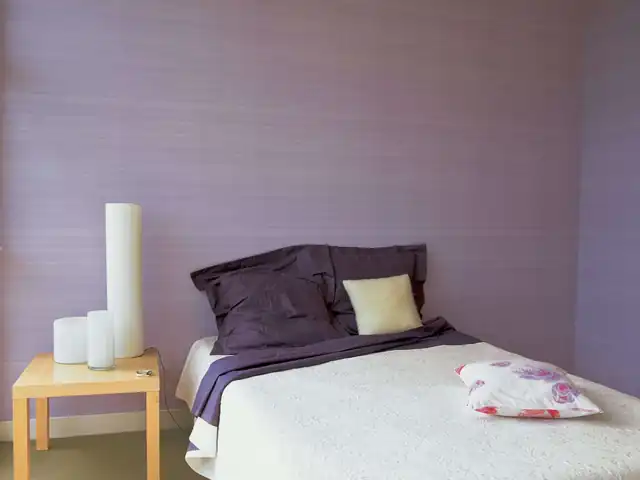 Soft lilac textured wallpaper in a calm contemporary bedroom