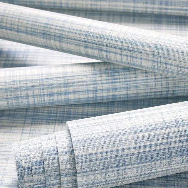 Rolled navy Bryson wallpaper showing its linen-mesh texture