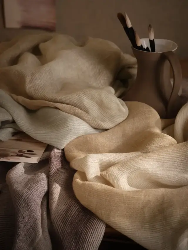 Neutral linen sheer fabrics showing their soft drape and open woven texture