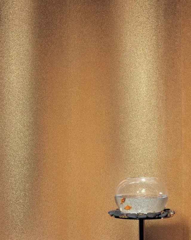 Gold Maya Romanoff Beadazzled wallcovering reflecting light across its glass bead surface