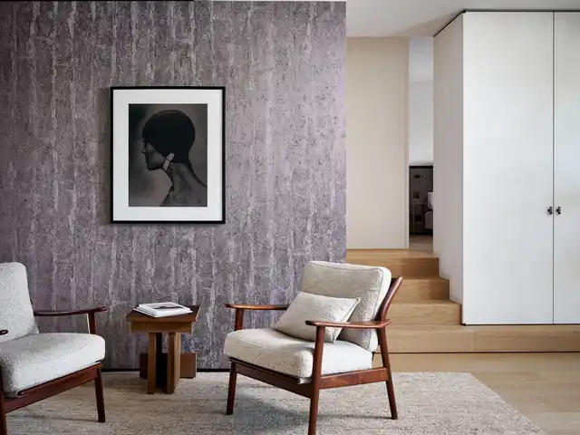 Patinated metallic purple wallcovering in a restrained modern interior