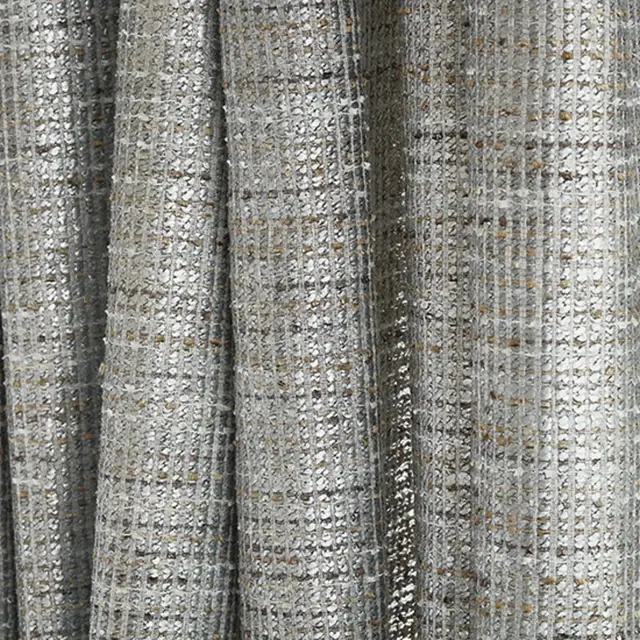 Close view of woven metallic sheer fabric with silver and gold threads