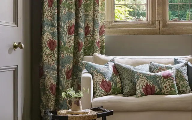 Morris and Co fabrics, curtains and cushions in a layered interior