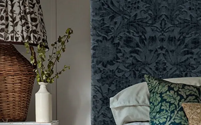 Upholstered headboard covered in Morris and Co patterned fabric