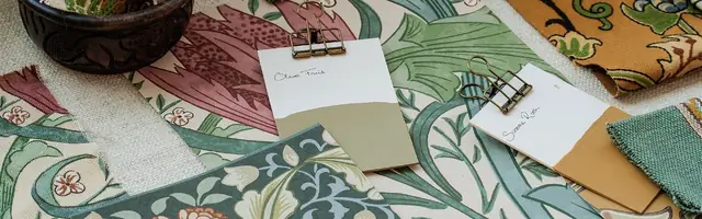 Morris and Co fabric, wallpaper and colour samples arranged for an interior scheme