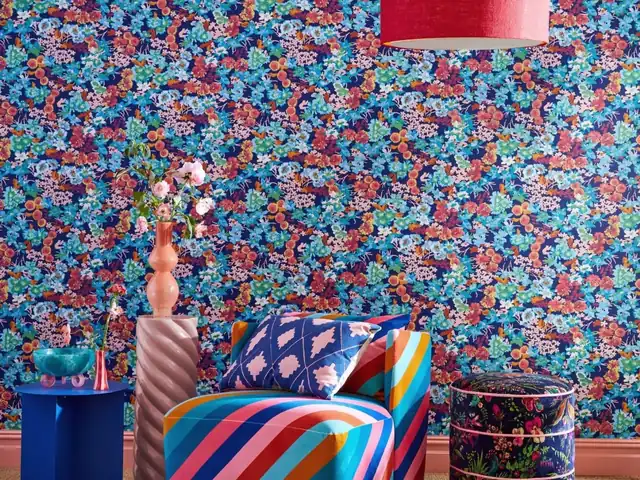 Bright multicoloured floral wallpaper in a richly layered interior
