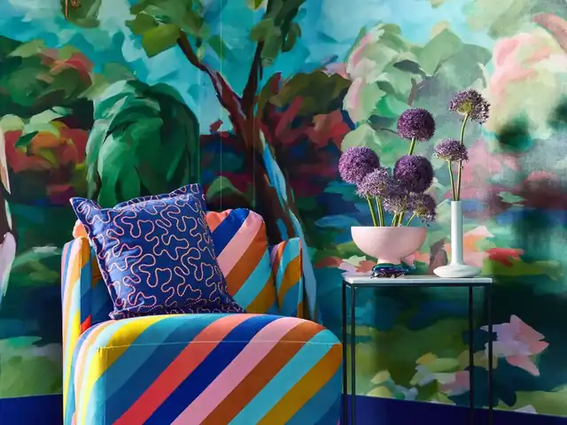 Painterly multicoloured woodland wallpaper used across a complete room
