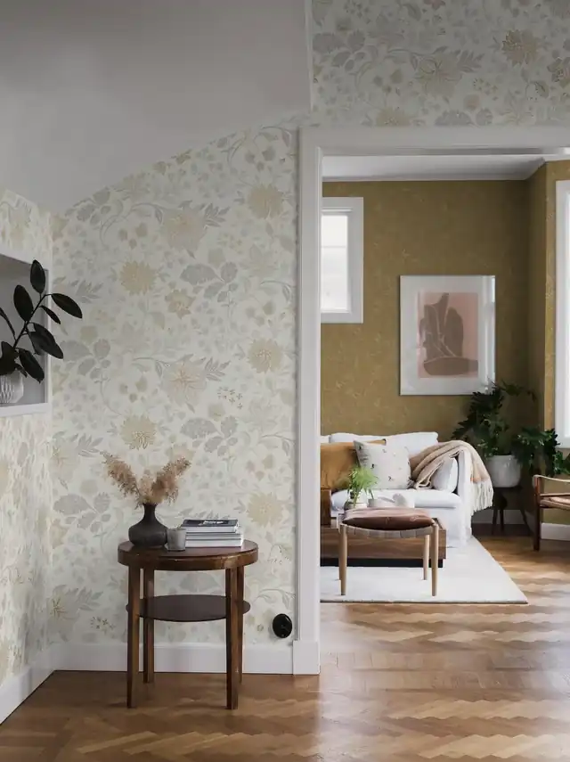 Light floral wallpaper connecting a narrow hallway with an adjoining room