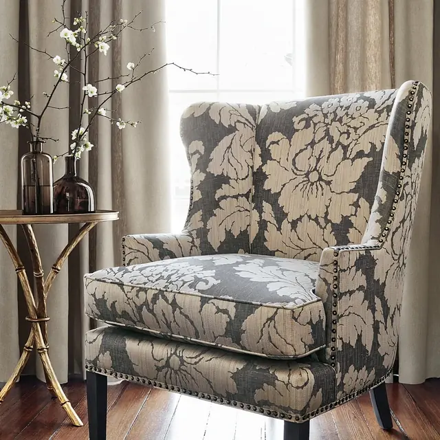 Neutral floral damask upholstery fabric on a classic armchair